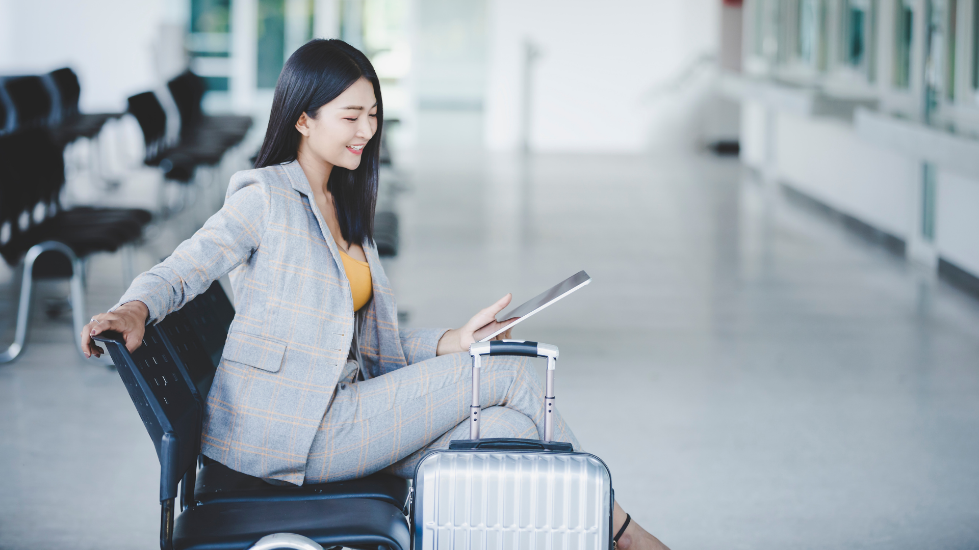 Woman on tablet in airport